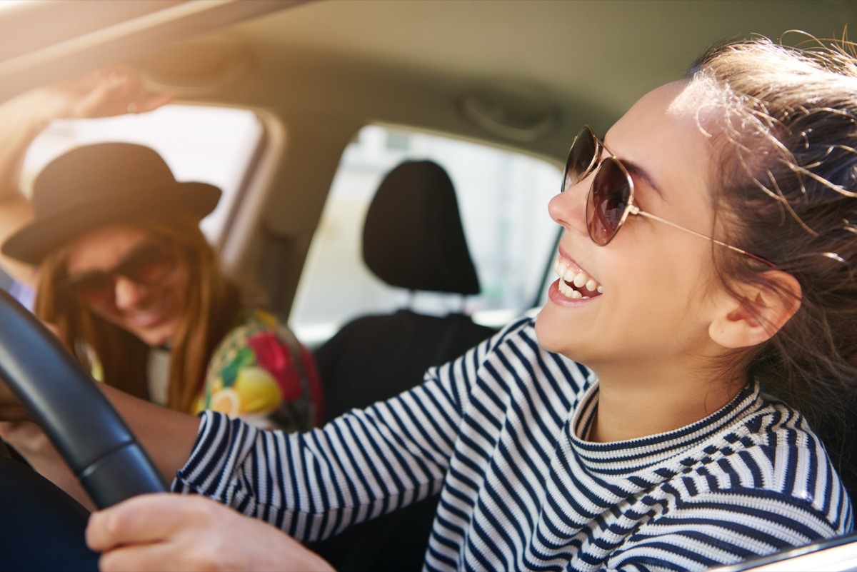 friends laughing in the car after one gives a funny response to 