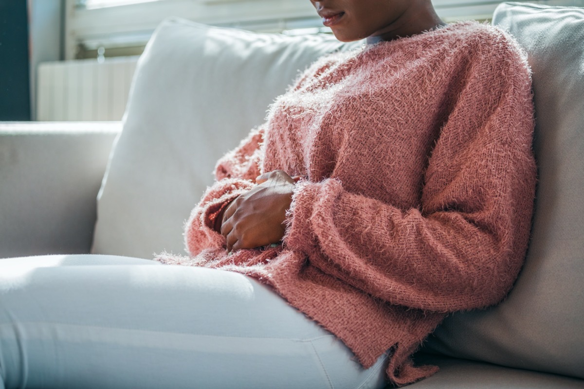 Young woman holding stomach