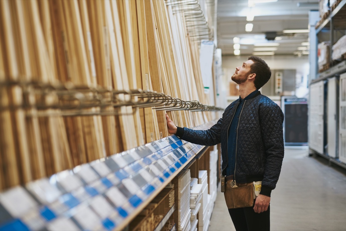 Man buying wood at store