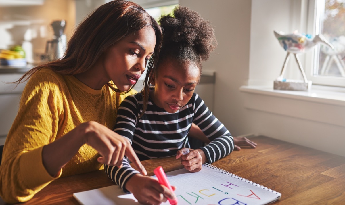 mother homeschooling daughter