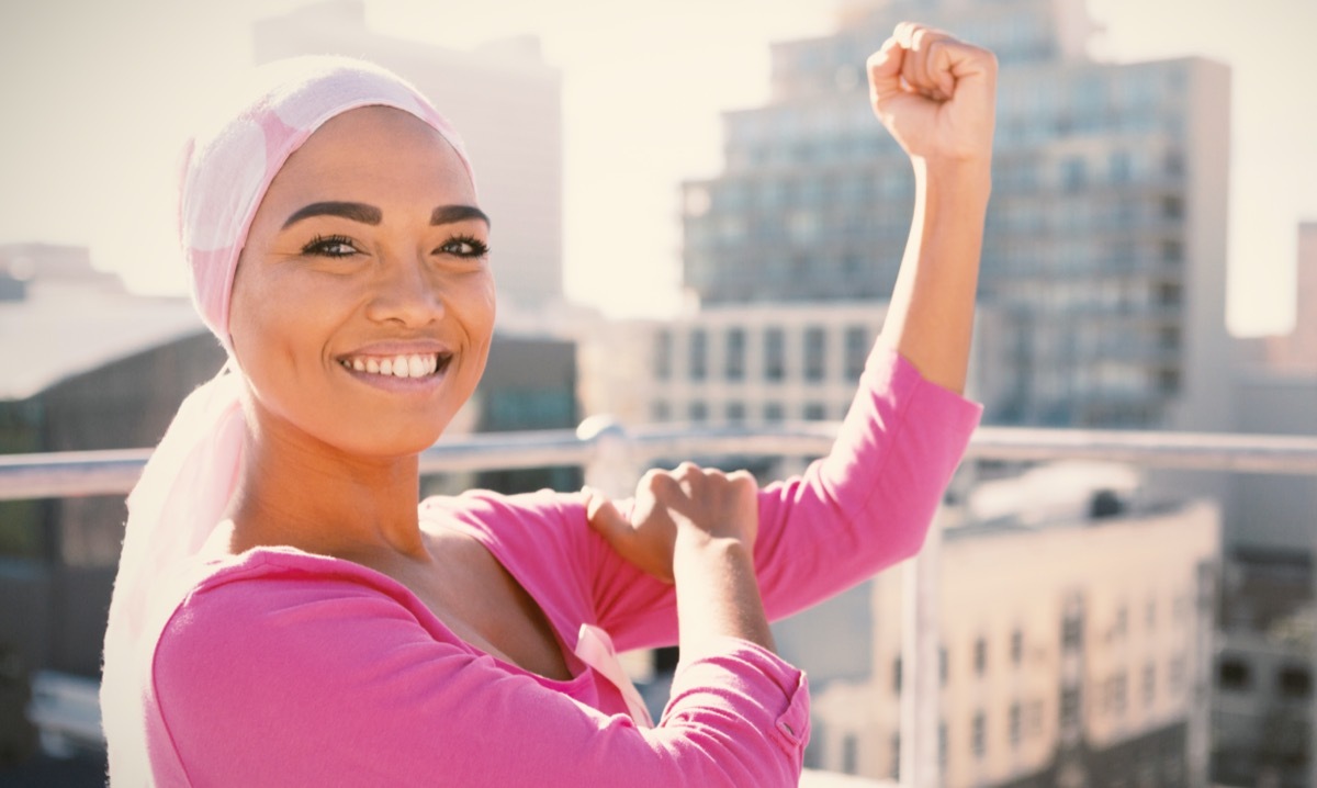 woman wearing mantra scarf in the city with breast cancer awareness