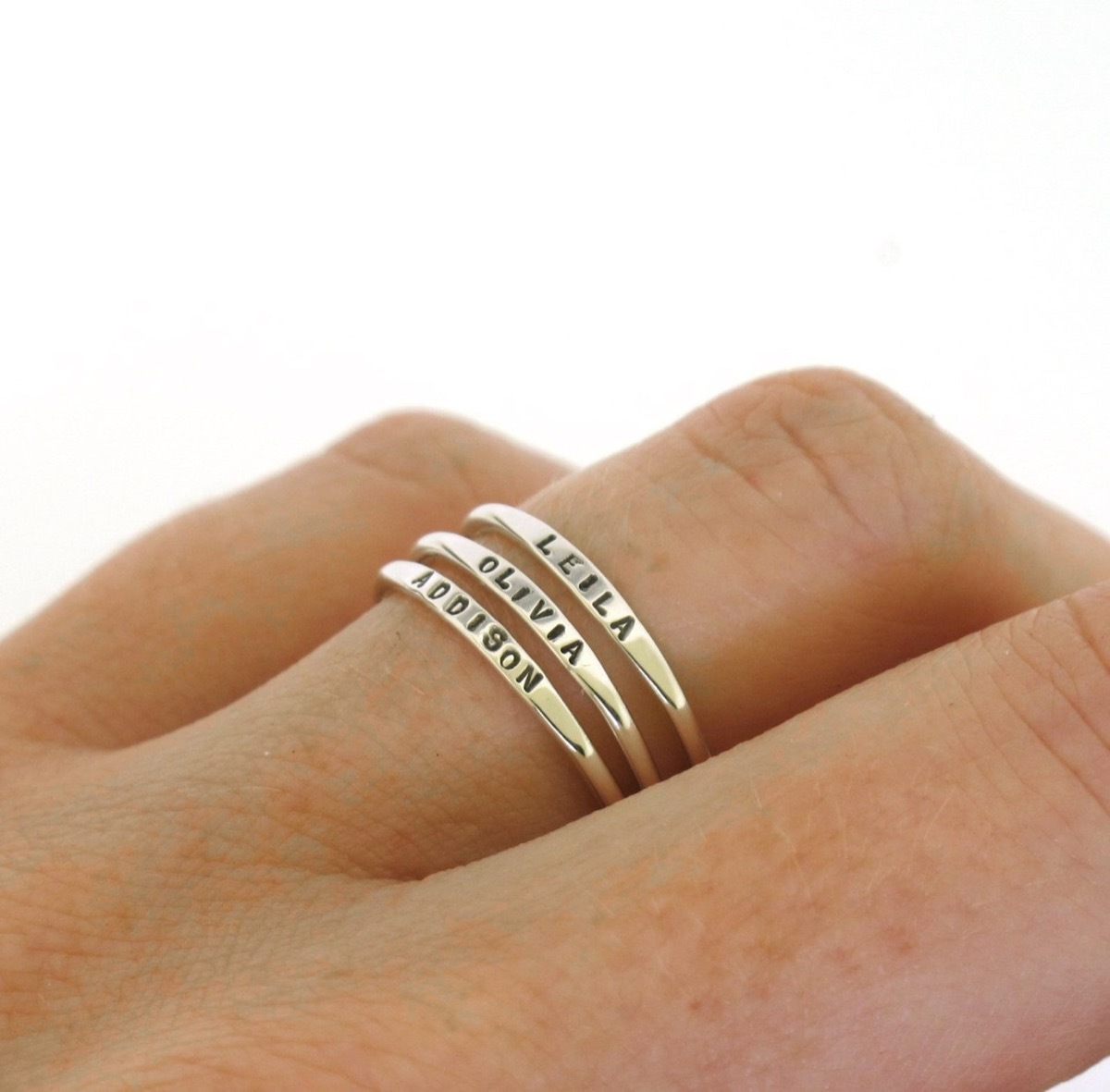 Stacking rings on woman's hand