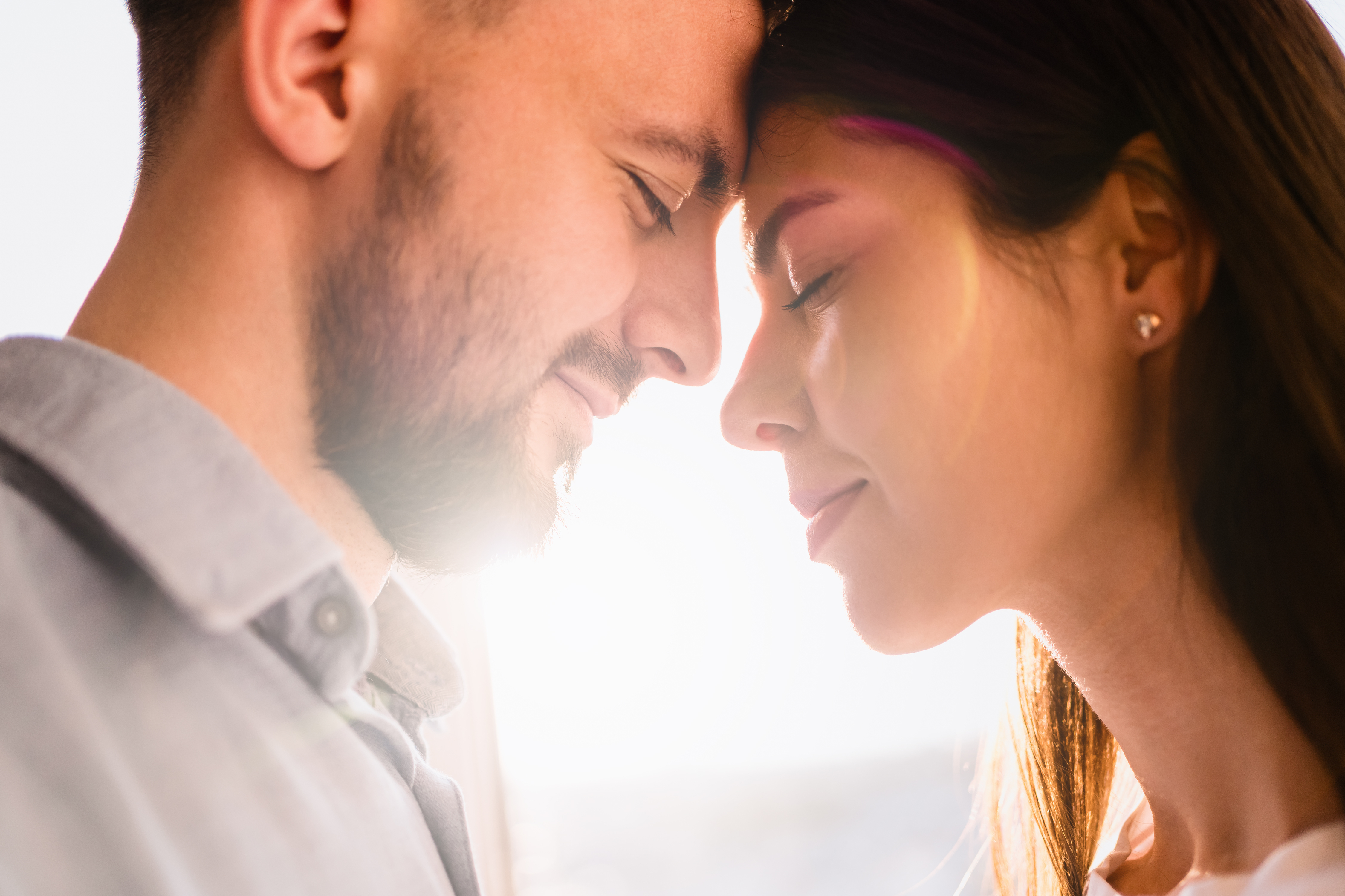 man and women pressing their foreheads together