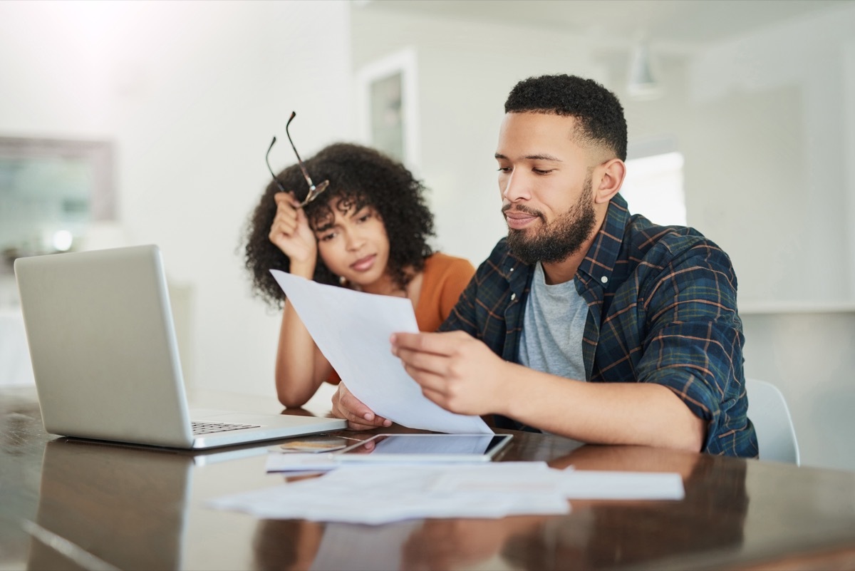 Shot of a young couple looking stressed while going over their finances at home