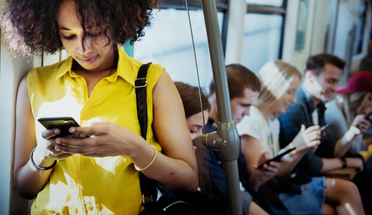 woman using a smartphone in a subway