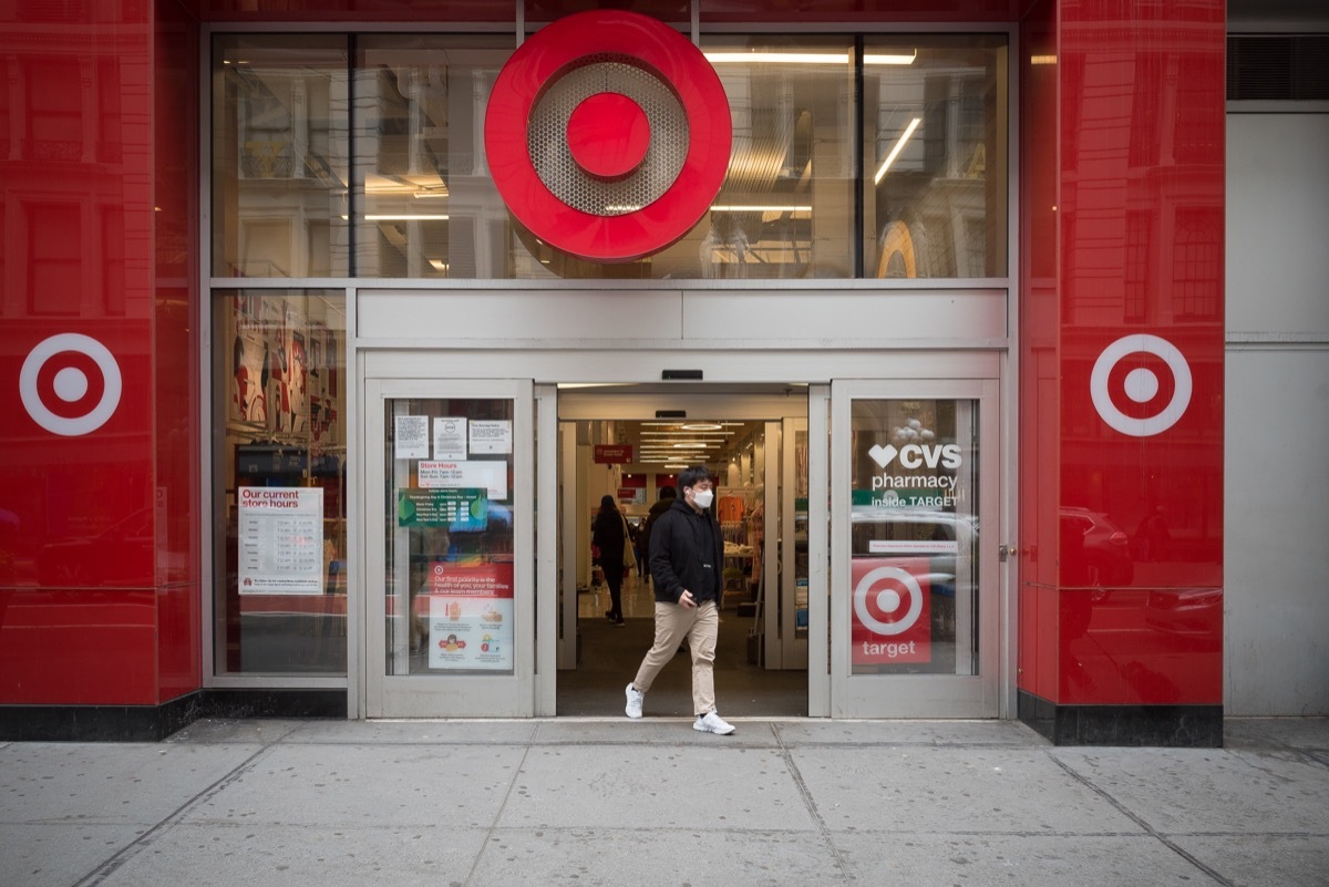 Manhattan, New York. March 24, 2021. A man wearing a mask exits a Target store on 34th street.