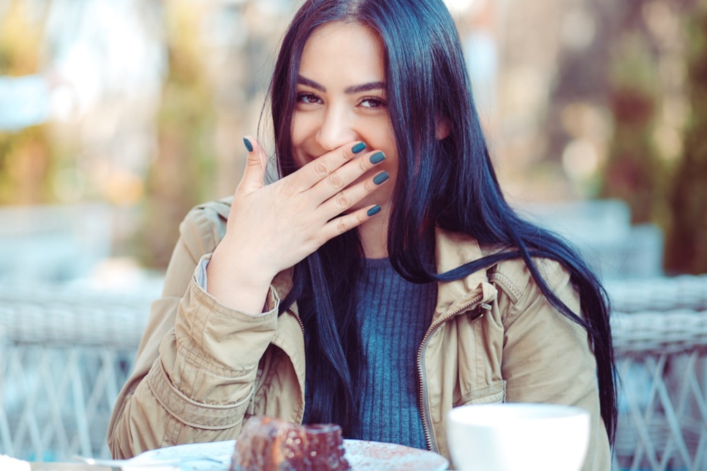 woman laughing to herself anti-jokes