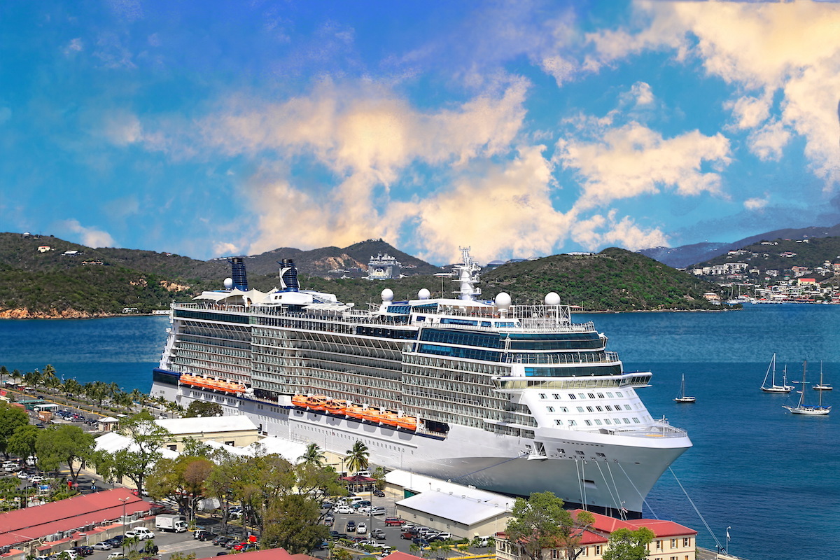 Cruise ship docked at an island.