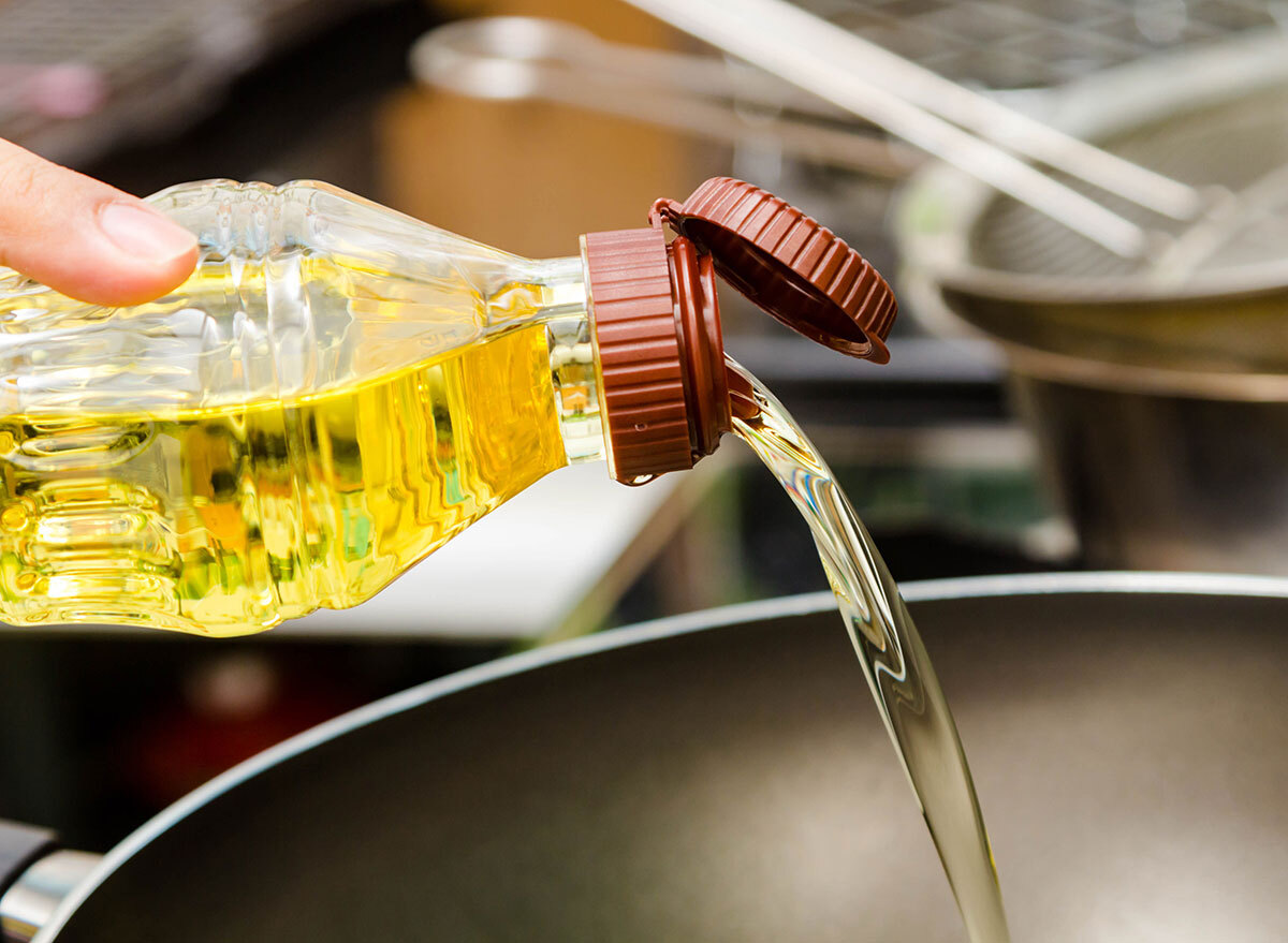 Pouring canola oil into pan