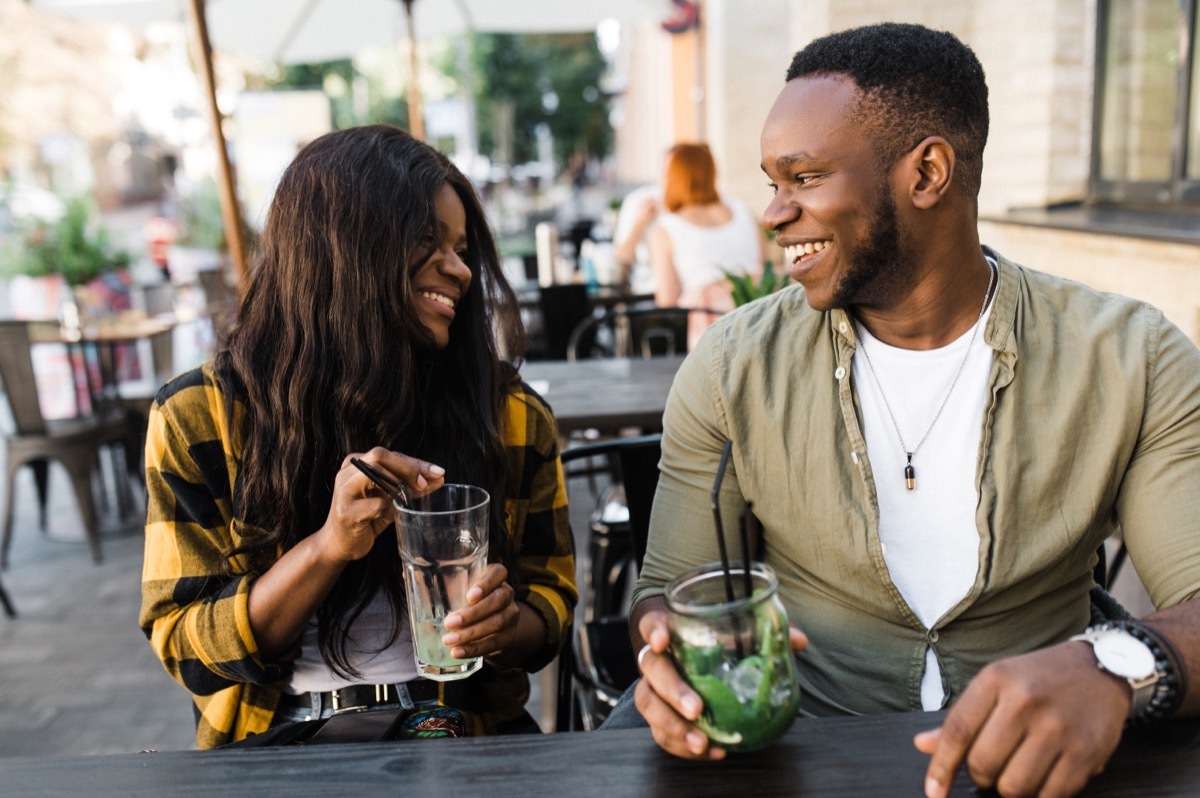 man and woman on a first date asking each other truth or drink questions