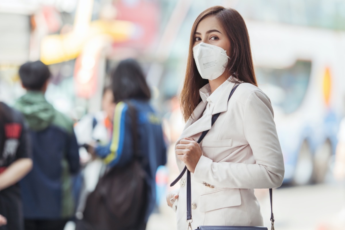 man with face mask back at work in office after lockdown