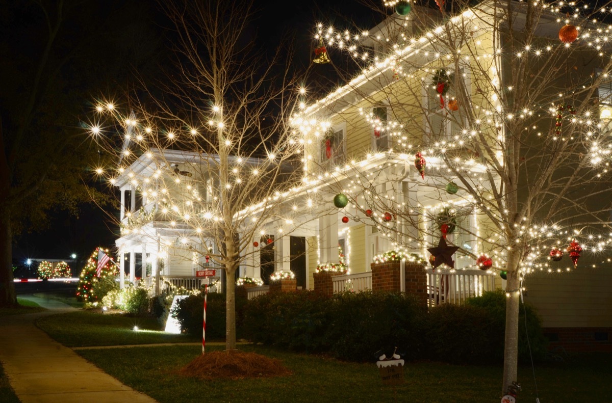 traditional wood-sided home decorated with christmas lights for the holiday season