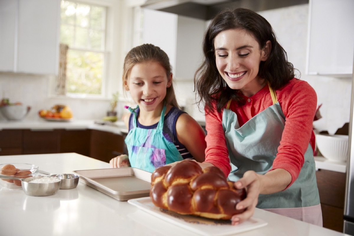 woman and young girl placing challah on kitchen counter, rosh hashanah facts