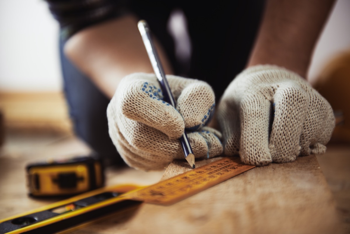 Measuring wood with ruler