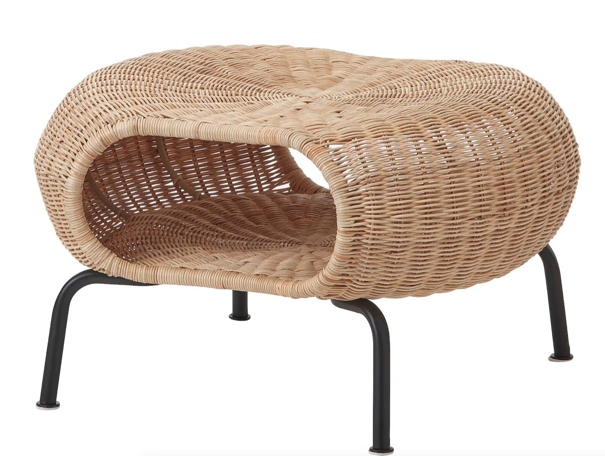 rattan ottoman with four black legs