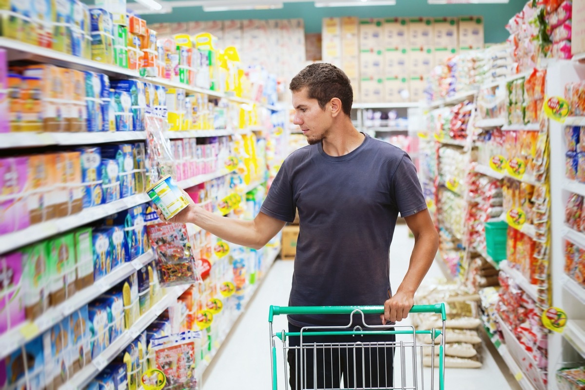 Man buying supplements at the grocery store