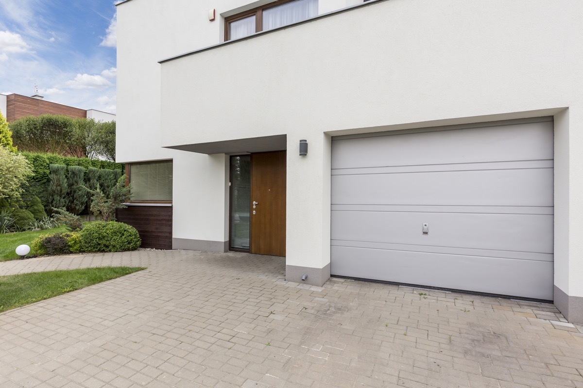 Modern front house entrance with one car garage