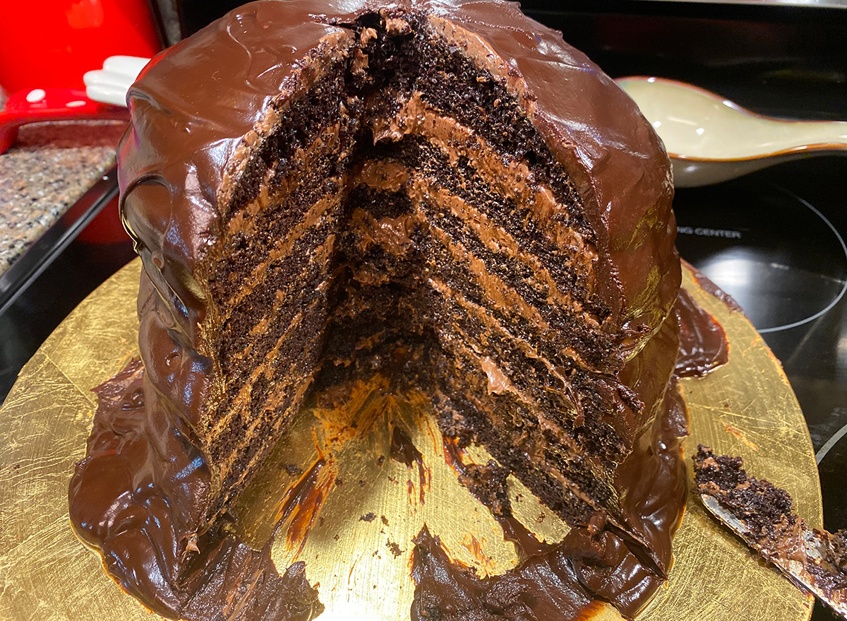 guy fieri seven layer chocolate cake with slice missing