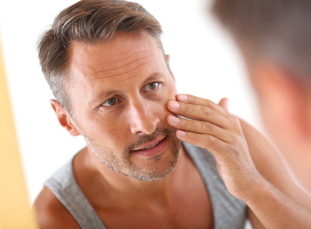 Man Applying Moisturizer Anti-Aging Tips You Should Forget