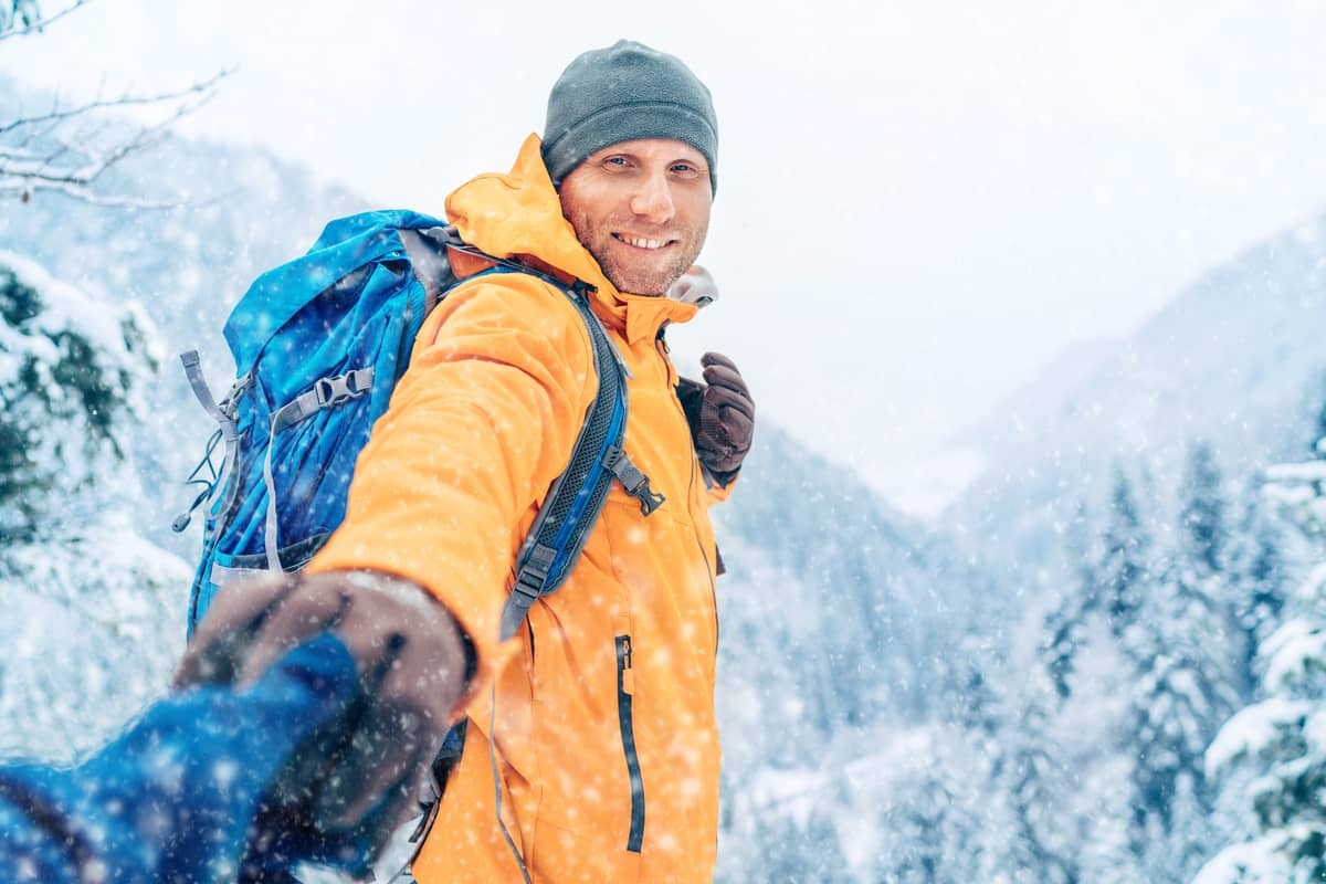 POV man in snow holding hands