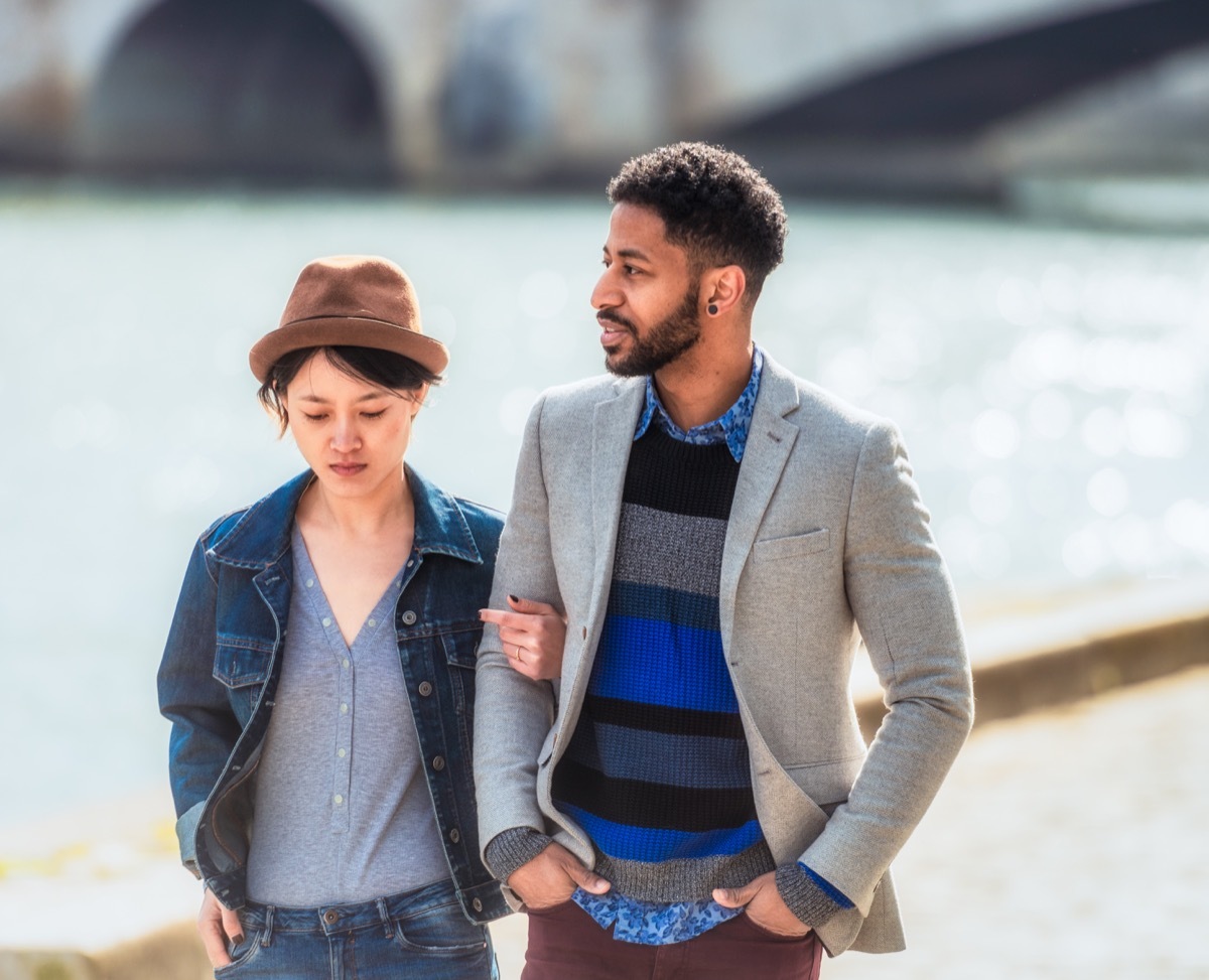 young couple walking along the river together