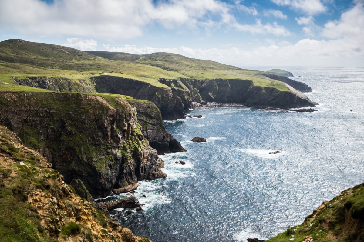 Up by the lighthouse on Arranmore Island, the 150 foot cliffs dominate the skyline with sea birds and rolling waves.