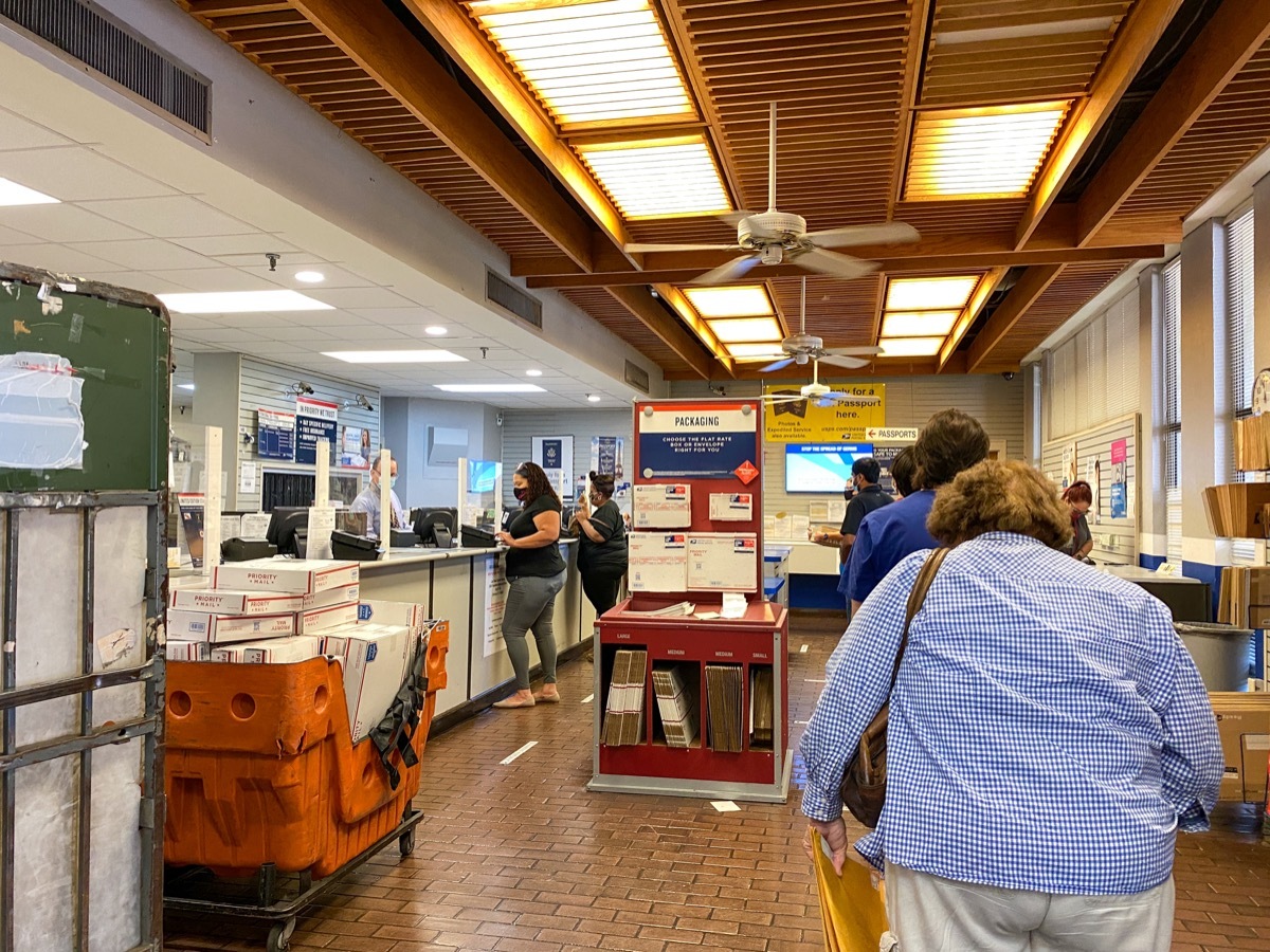 People waiting in line at a United States Post Office in Orlando, Florida where people are wearing face masks and social distancing,