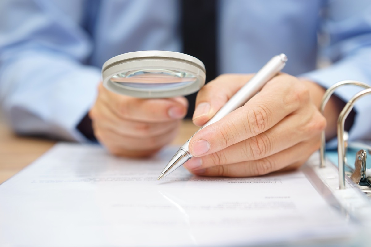 Man Studying a Paper Through a Magnifying Glass Commonly Misused Phrases