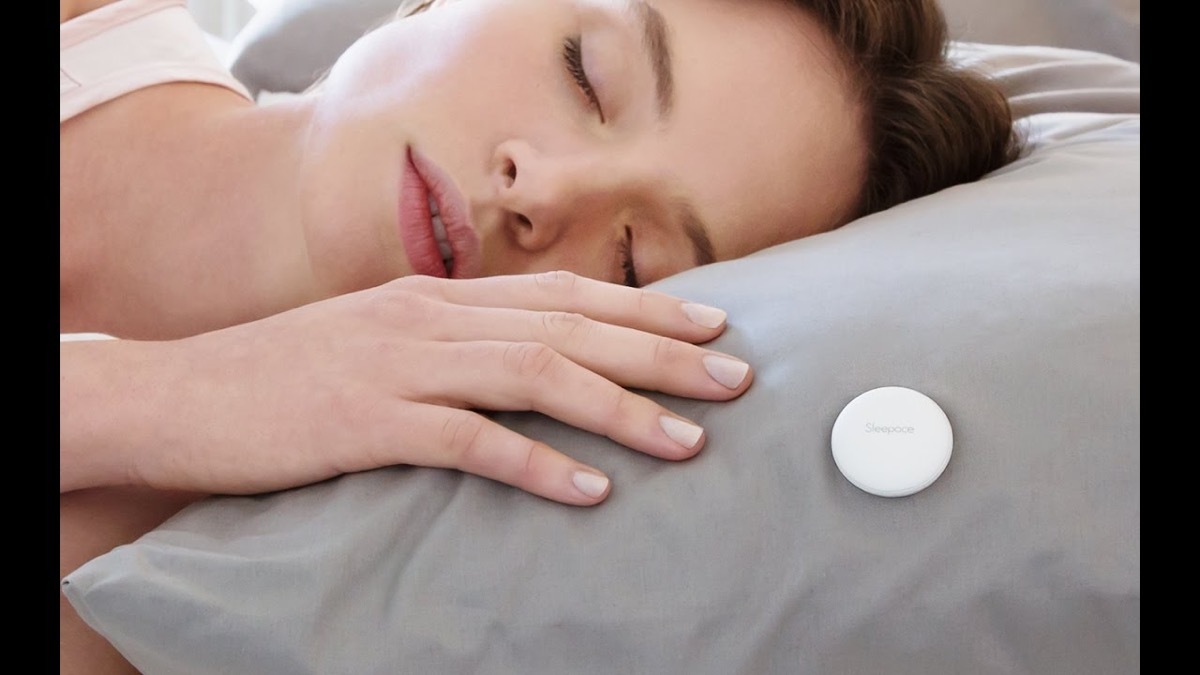 woman sleeping with white button on her gray pillow, labor day tech sales