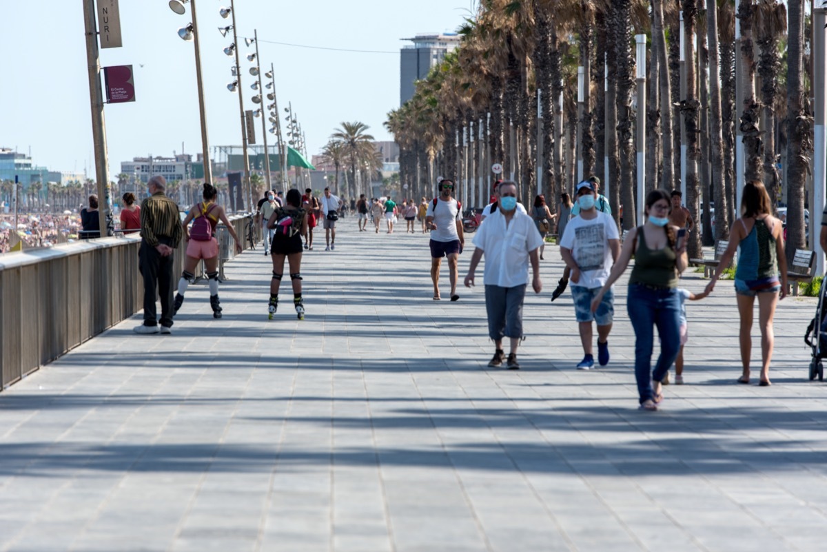 exterior shot of crowded barcelona boardwalk in june 2020