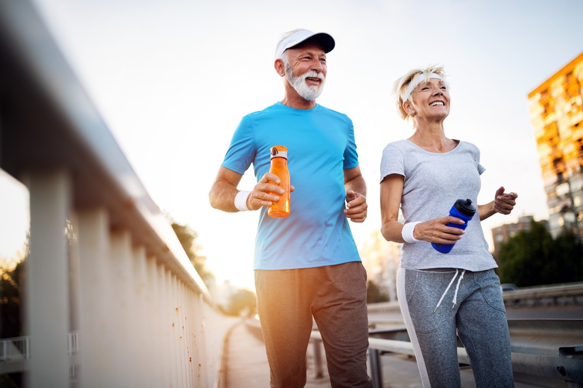 older white couple jogging outside