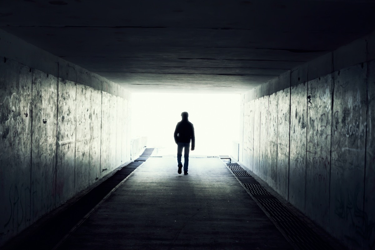 Silhouette of man in a subway tunnel