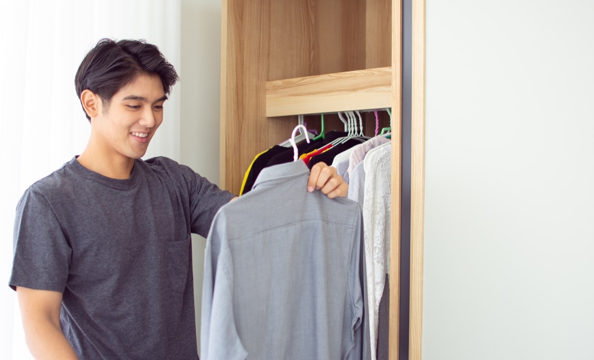 Man looking at a shirt