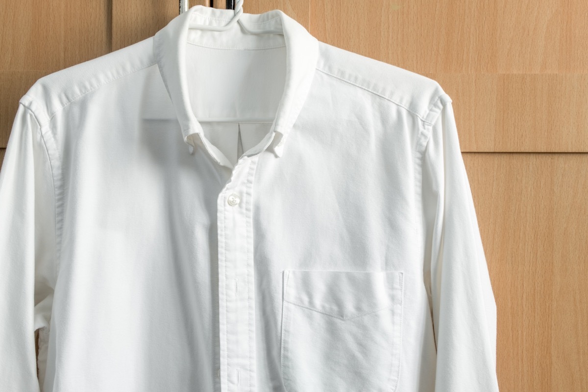 white button down shirt hanging up