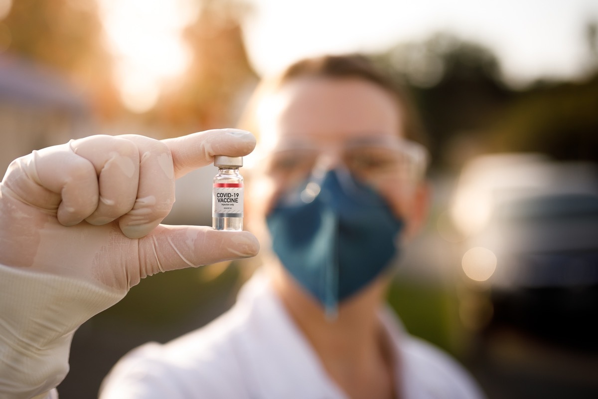 Woman holding covid-19 vaccine.