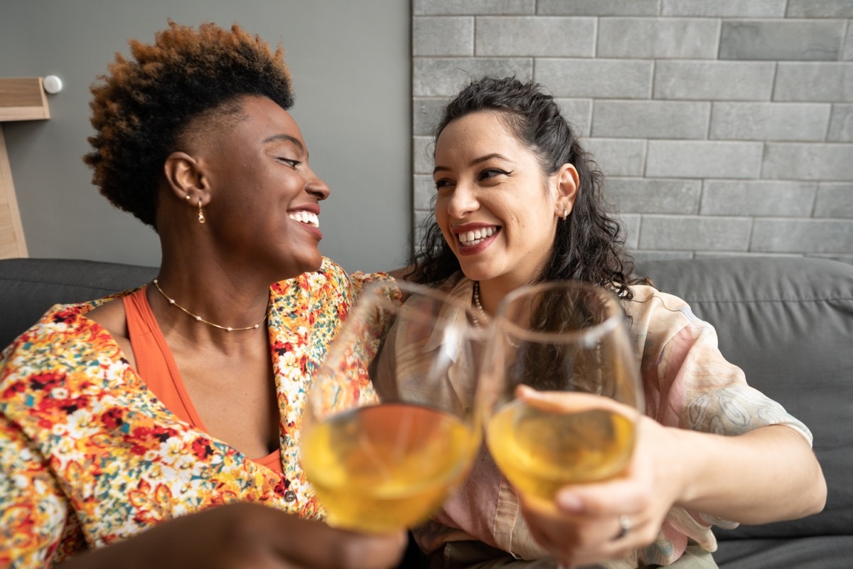 two women drinking wine celebrating their anniversary