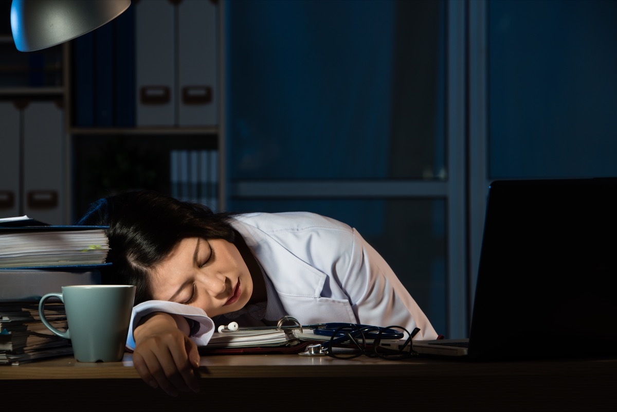 doctor feel tired sleeping on desk of clinic