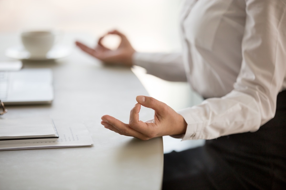 Woman taking a break to meditate at work