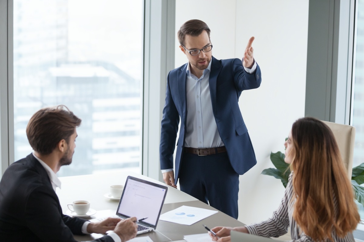 white male coworker yelling at younger female and male office employees