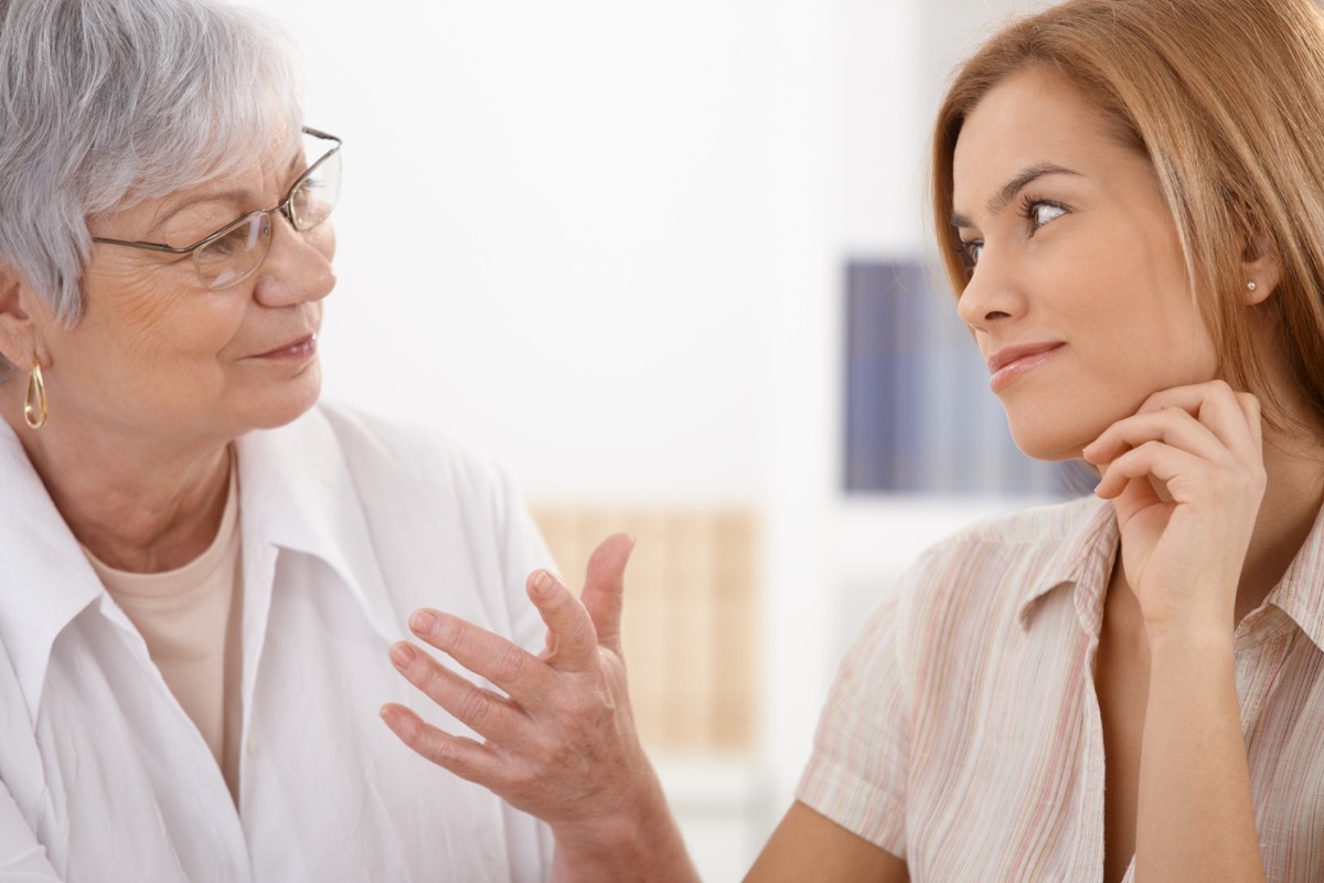 Senior mother and attractive daughter looking at each other