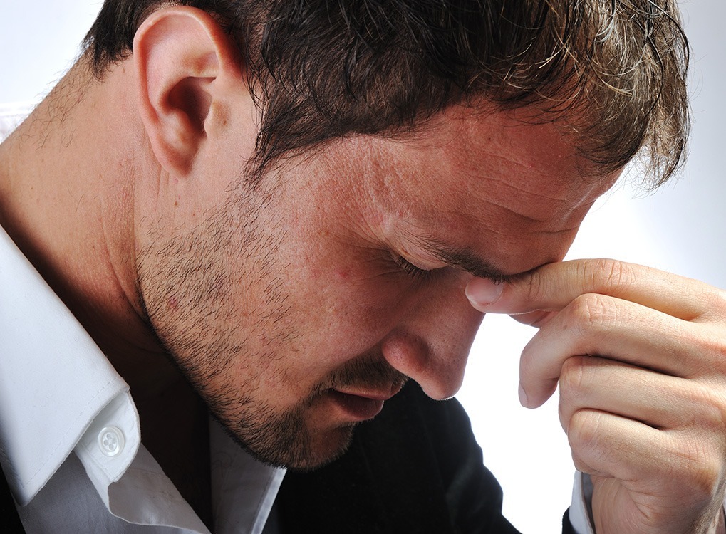 man looks stressed furrows his brow, ways your body changes after 40