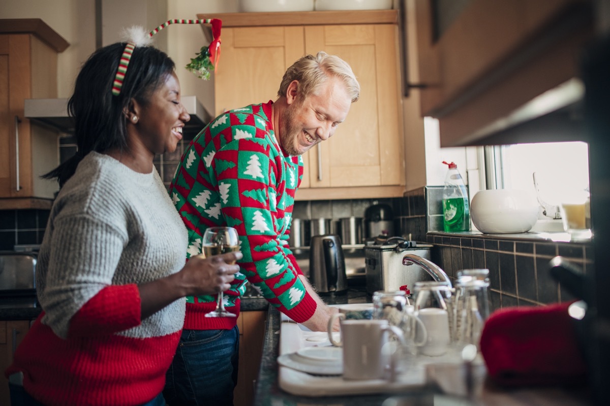 People cleaning up in the kitchen after Christmas