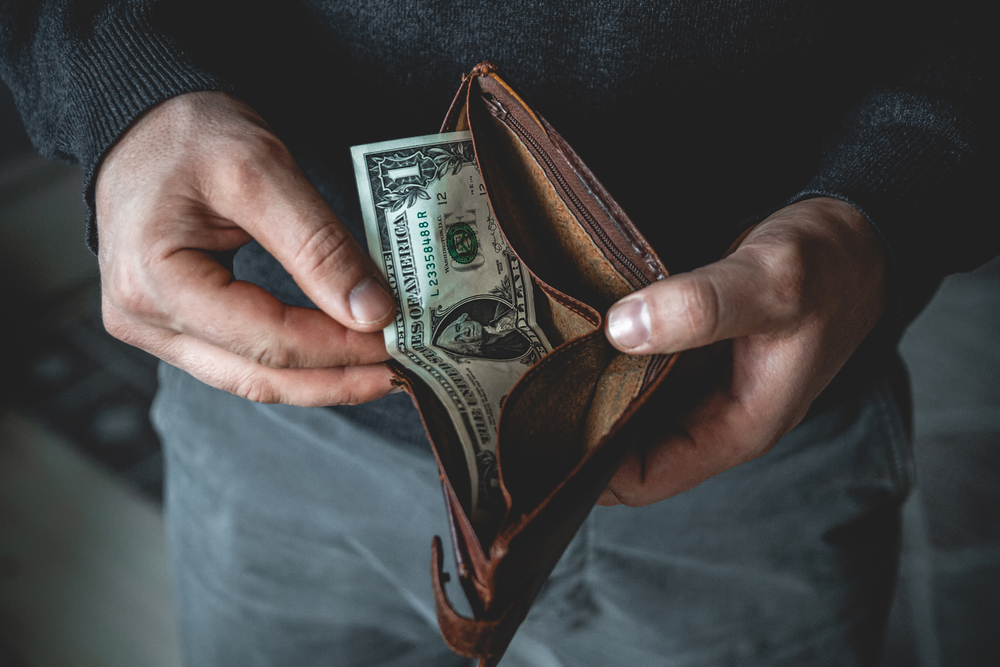 man with wallet getting money out