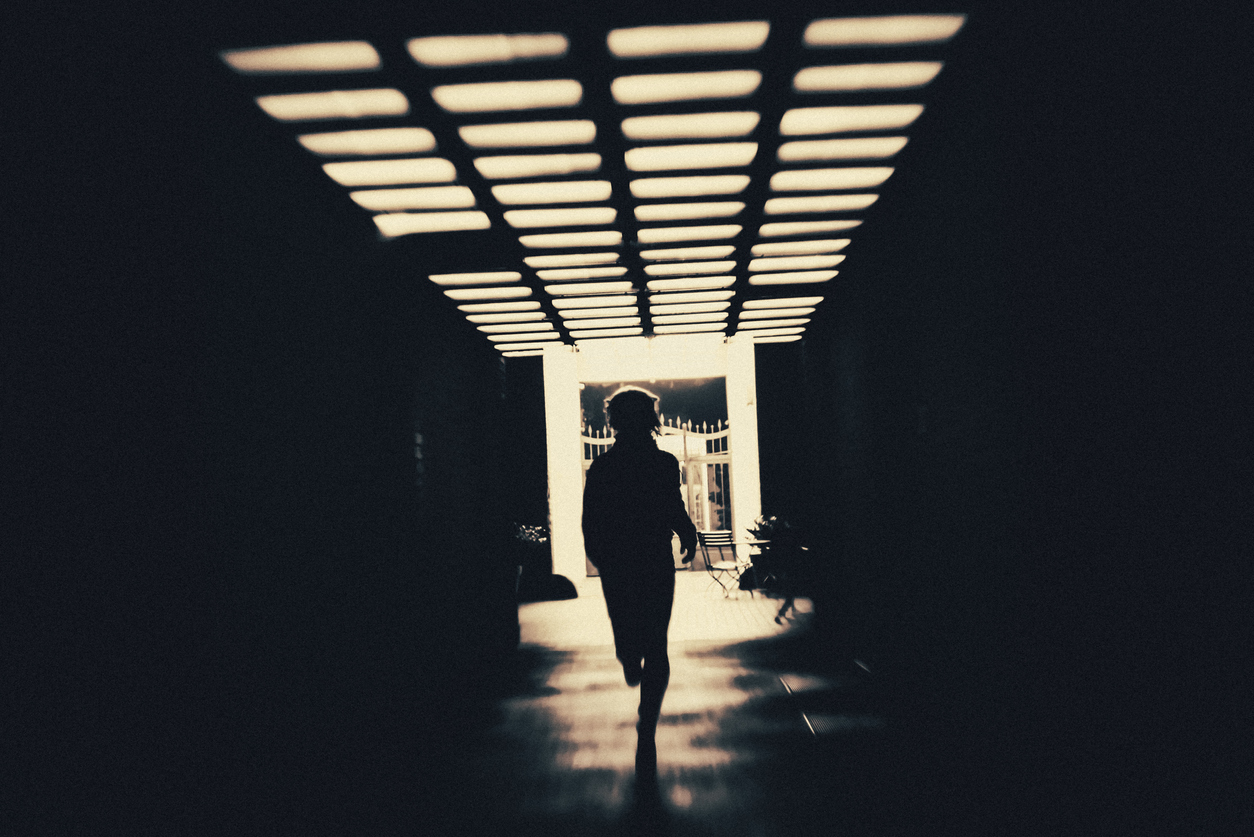 young person running alone under an overpass