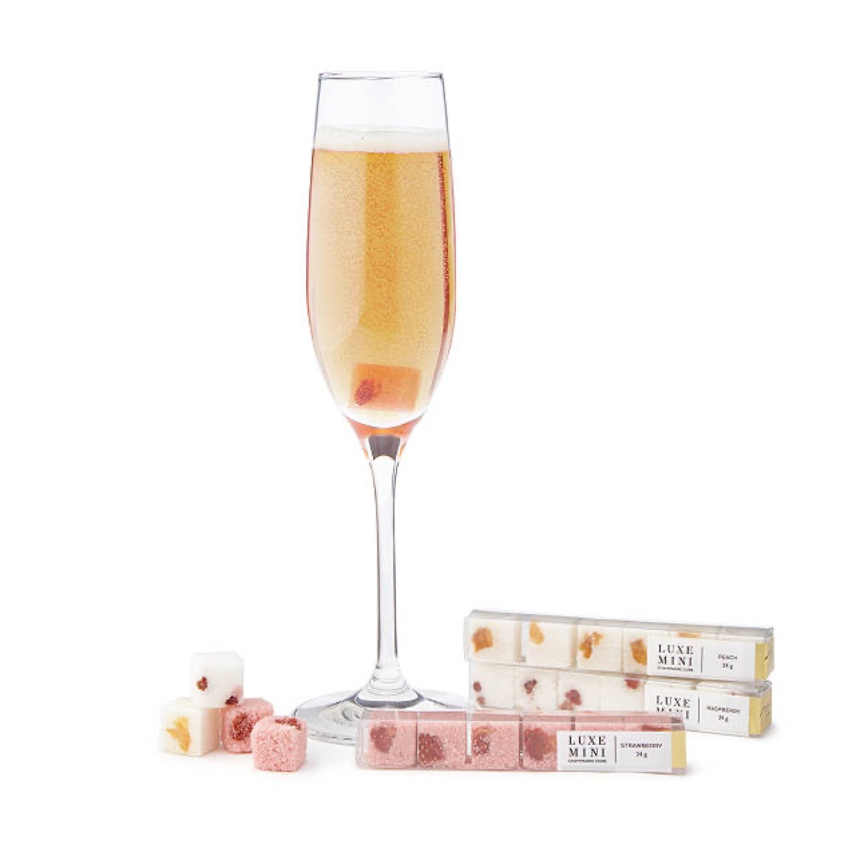 champagne glass next to pink sugar cubes