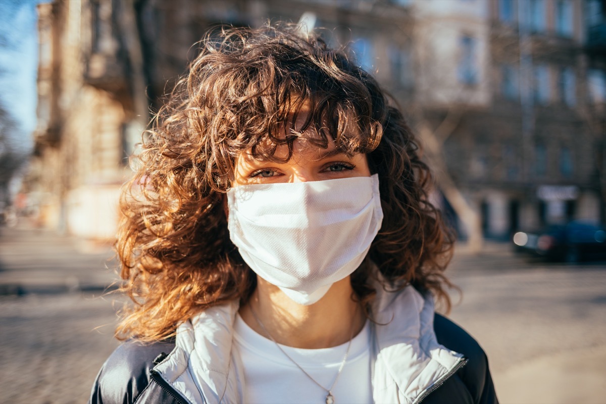 Girl wearing a mask outside