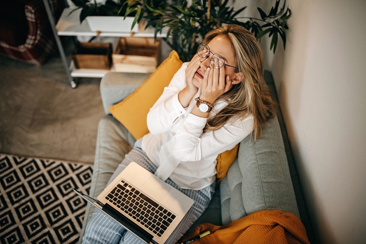 Tired women using laptop at home