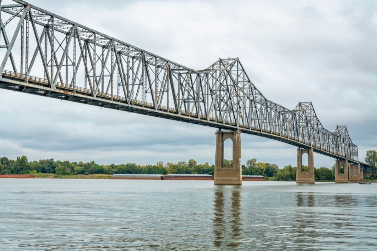 Cantilever Cairo Ohio River Bridge in fall scenery with river barges in backgroiund, it provides river crossing between Wickliffe, Kentucky and Cairo, Illinois.