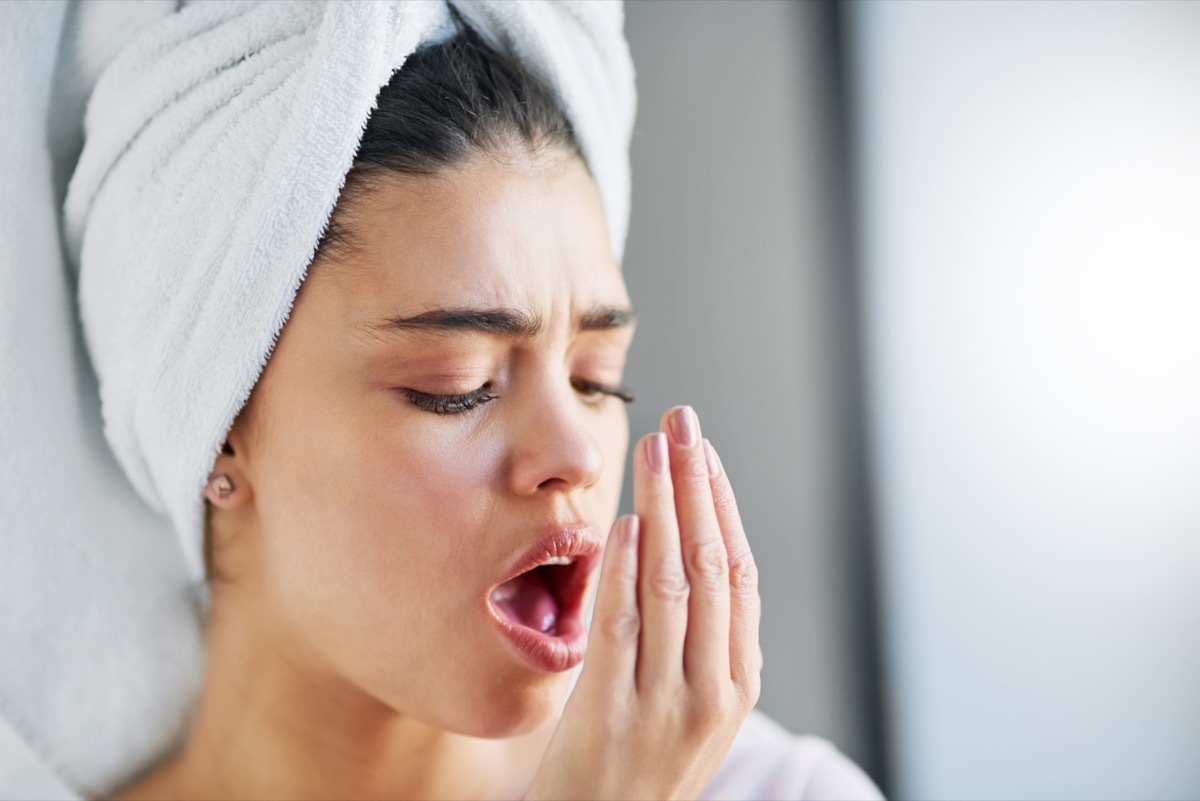 Woman checking her breath.