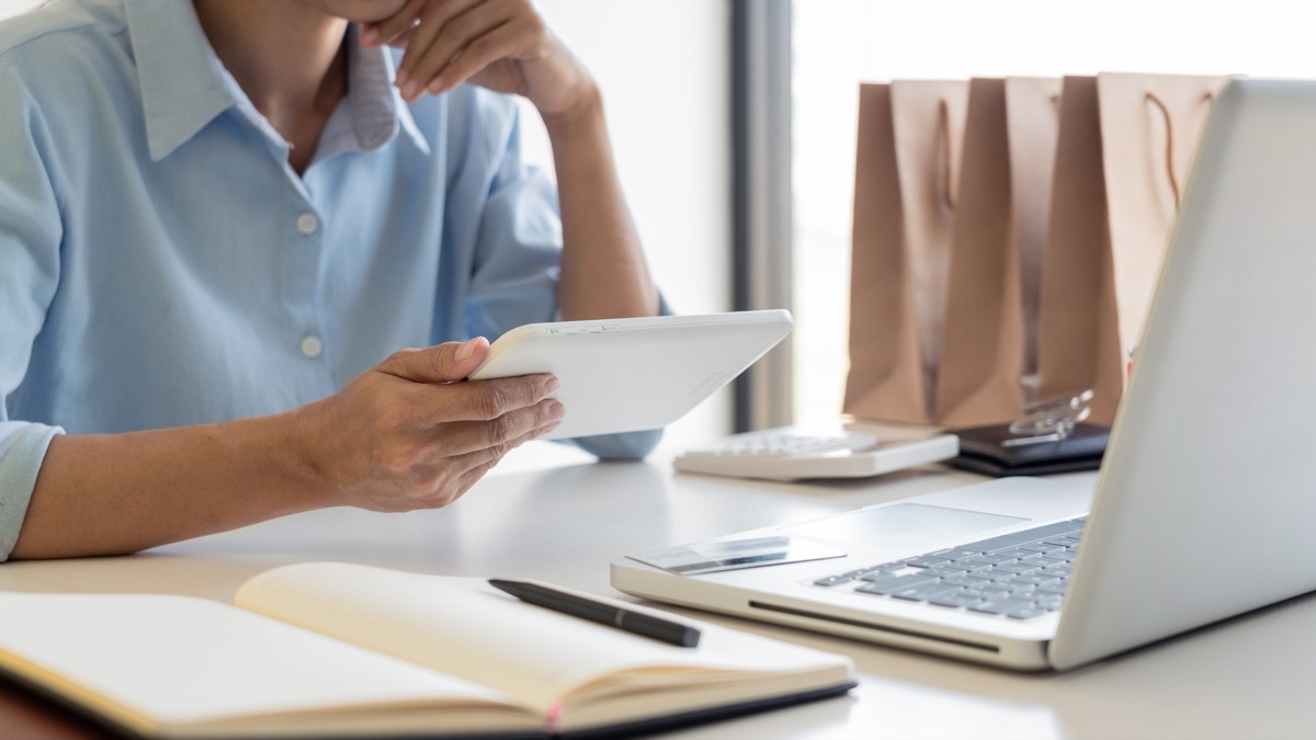 Man online shopping with laptop and tablet